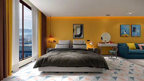 A modern bedroom design featuring a large bed with a cozy blanket, bright yellow walls, and large windows offering a city view. Incorporating Homestyler's real-time 3D rendering, this interior decor style emphasizes vibrant colors and contemporary furnishings.