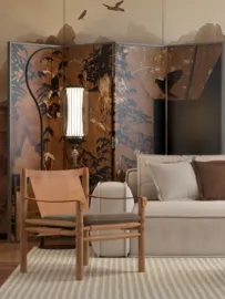 Stylish armchair and sofa arrangement with decorative folding screen in a modern design style, showcasing interior decor with Homestyler's real-time 3D rendering feature.